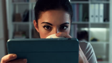 Attractive-woman-using-digital-tablet-touchscreen-computer-at-home